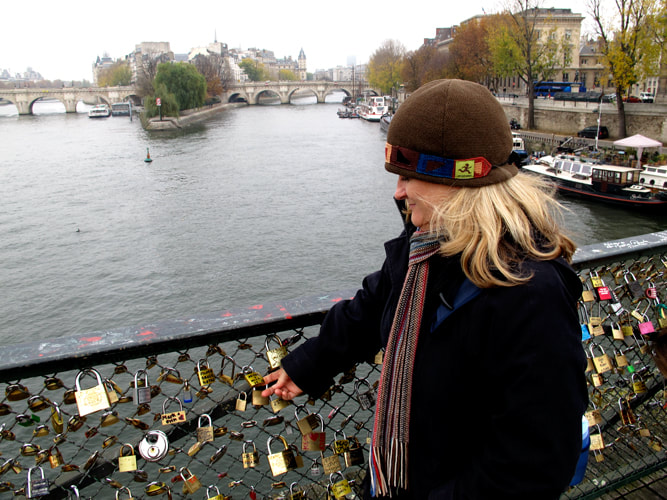 Locks on a bridge overlooking la Seine river in Paris France with Diana Saint James, Travel Agent